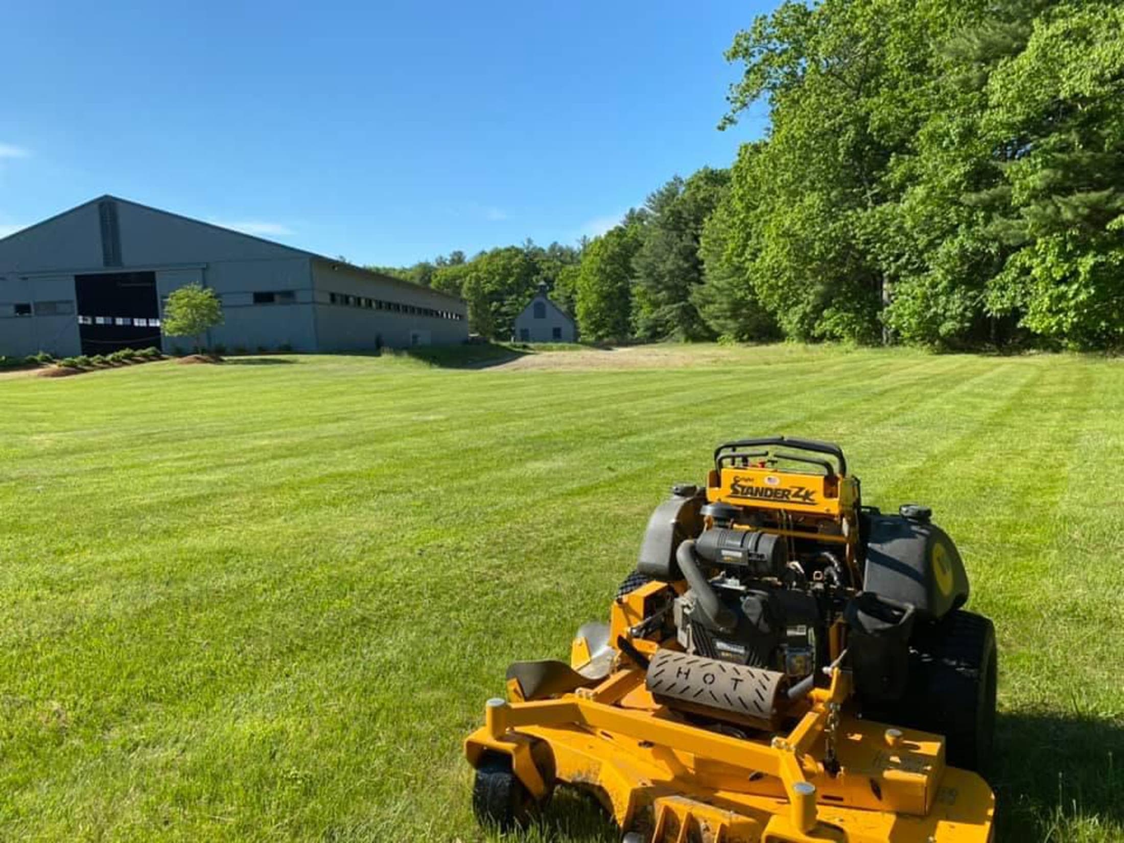 Commercial mower on a large, freshly maintained lawn